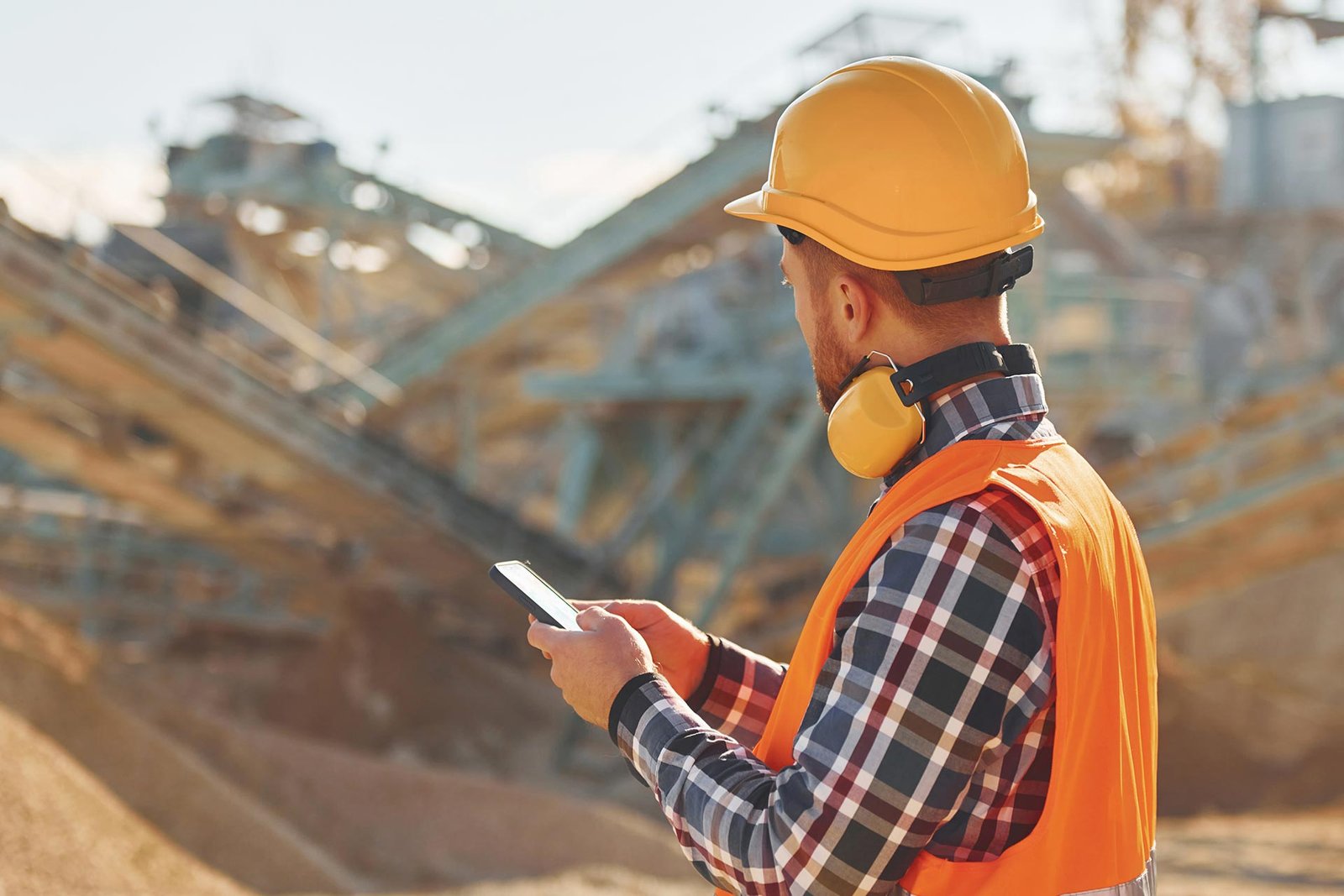 with-yellow-headphones-on-neck-construction-worke-2023-11-27-05-15-20-utc